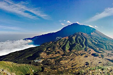 Mount Meru rising above a layer of cloud
