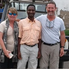 Gabriel Mrema, driver guide, with two guests